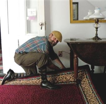 John Burrows inspects new carpet.
